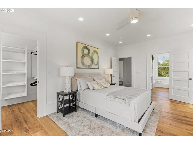 a bedroom with a bed and painting on the wall