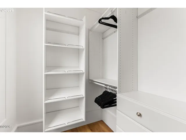 a walk in closet with a rug