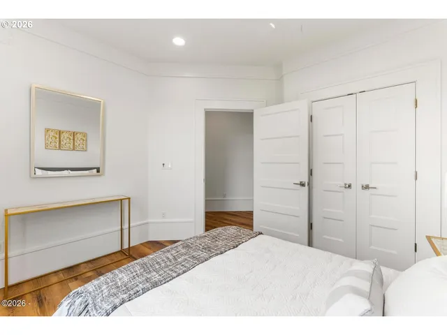 a bedroom with a bed and a painting on the wall