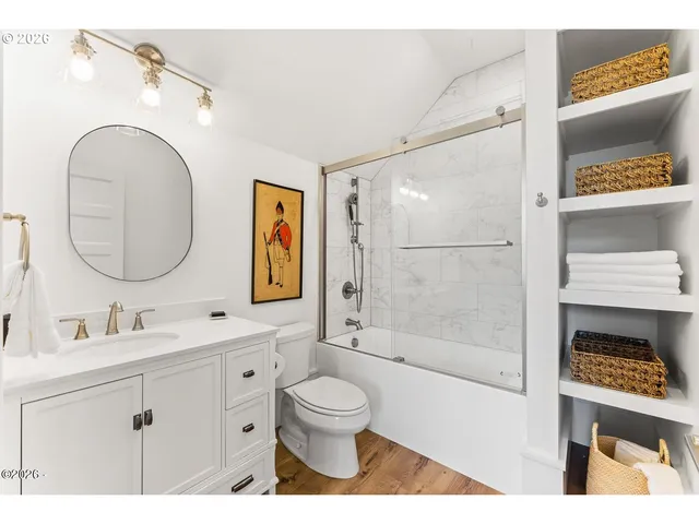 a bathroom with a toilet a sink and a mirror