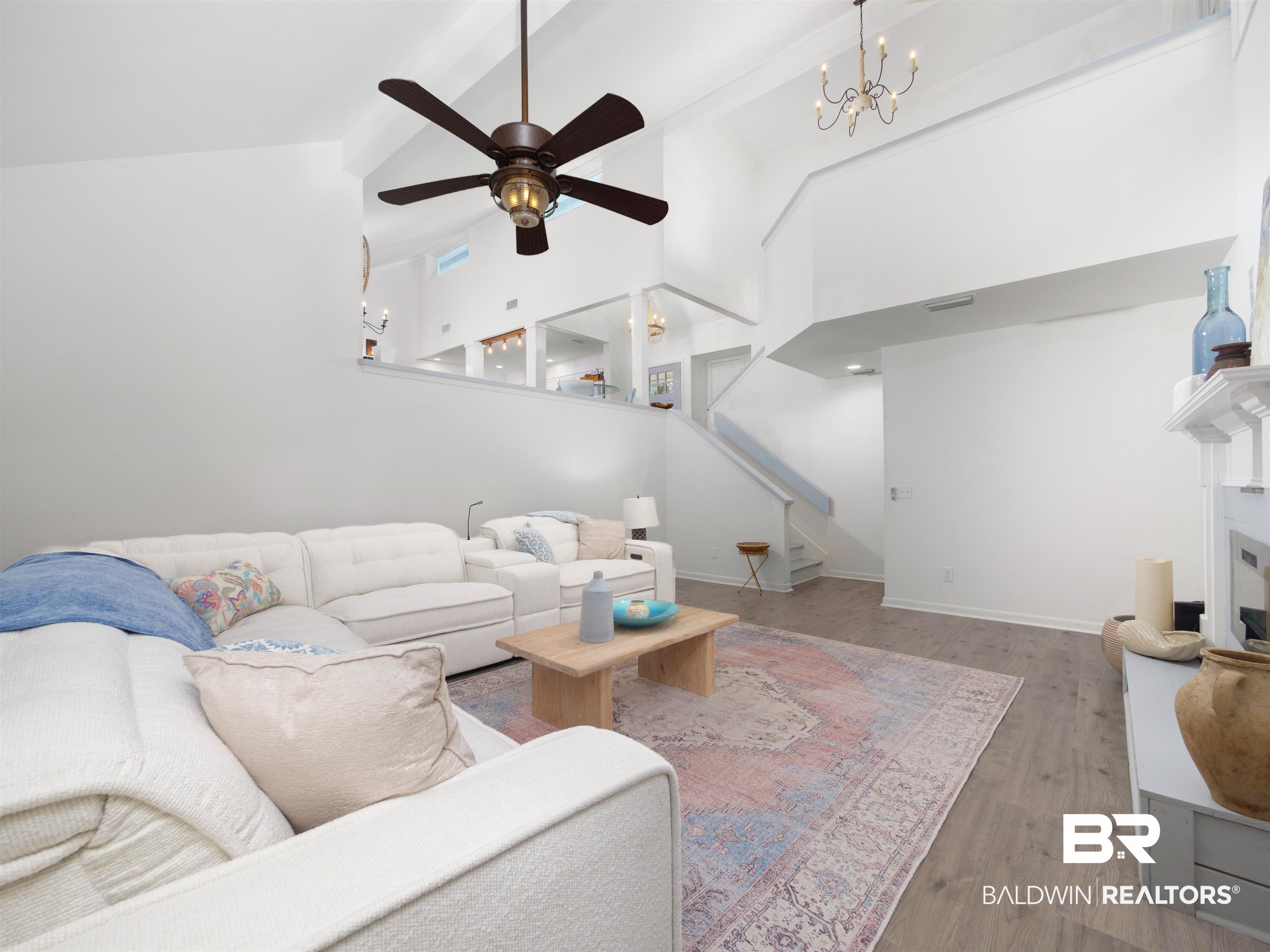 494 Ridgewood Drive Daphne, AL 36526 - Photo 17 of 40 Living room with hardwood / wood-style flooring, beamed ceiling, high vaulted ceiling, and ceiling fan with notable chandelier