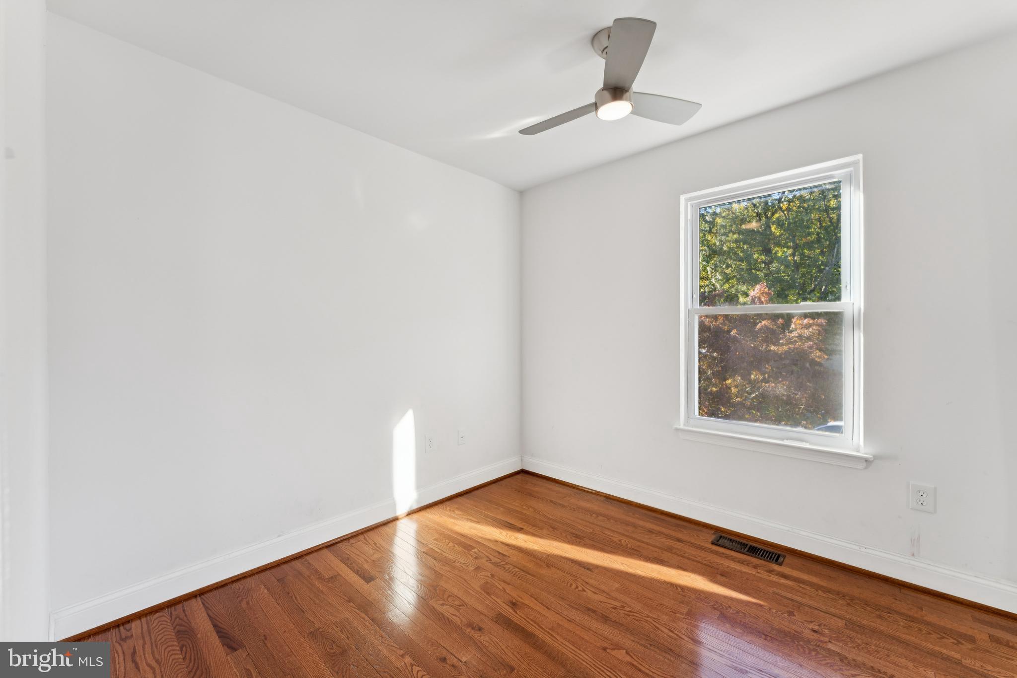 2107 High Timber Road Fort Washington, MD 20744 - Photo 15 of 30 a view of empty room with wooden floor and fan