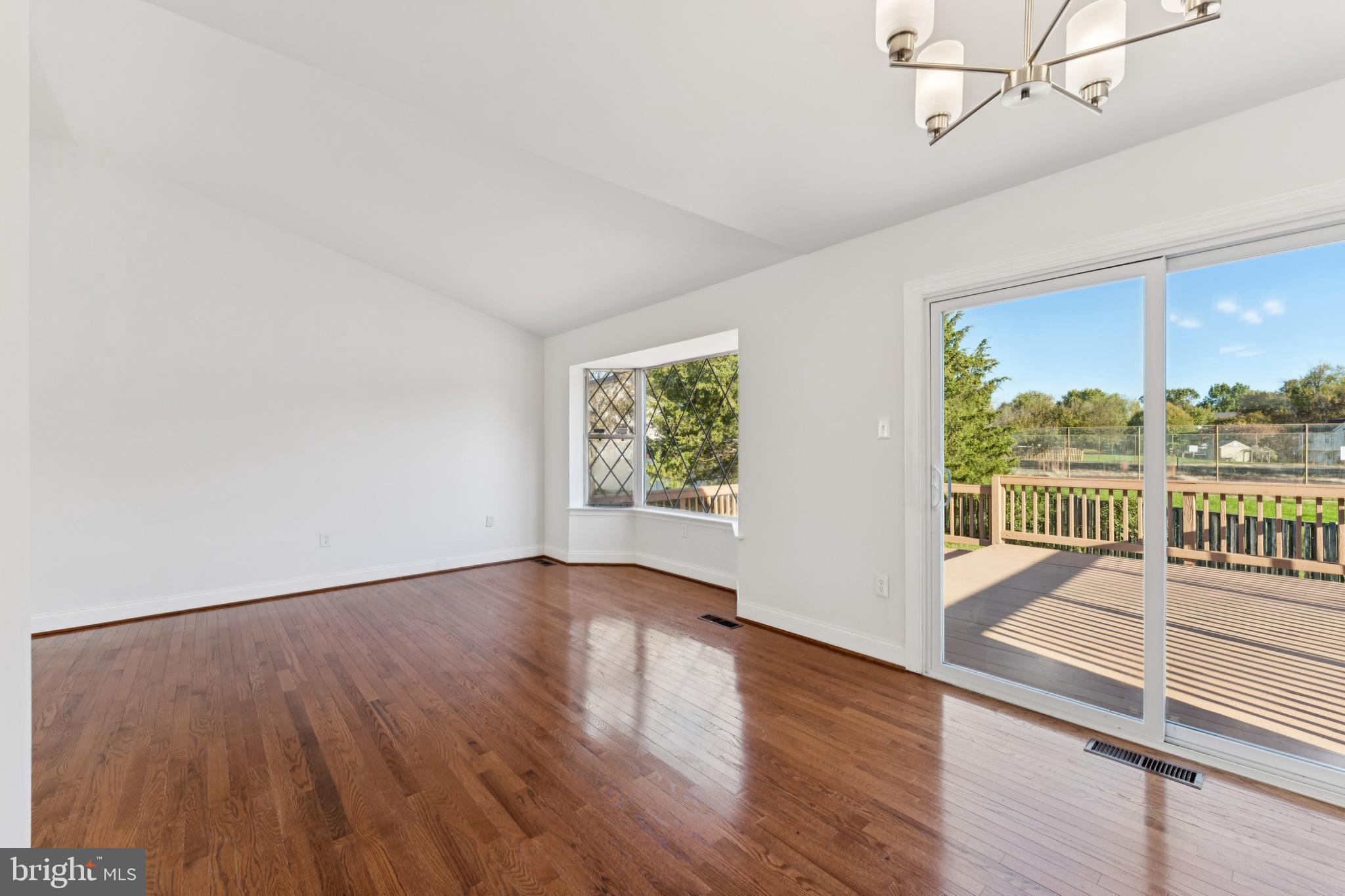 2107 High Timber Road Fort Washington, MD 20744 - Photo 7 of 30 an empty room with wooden floor and windows