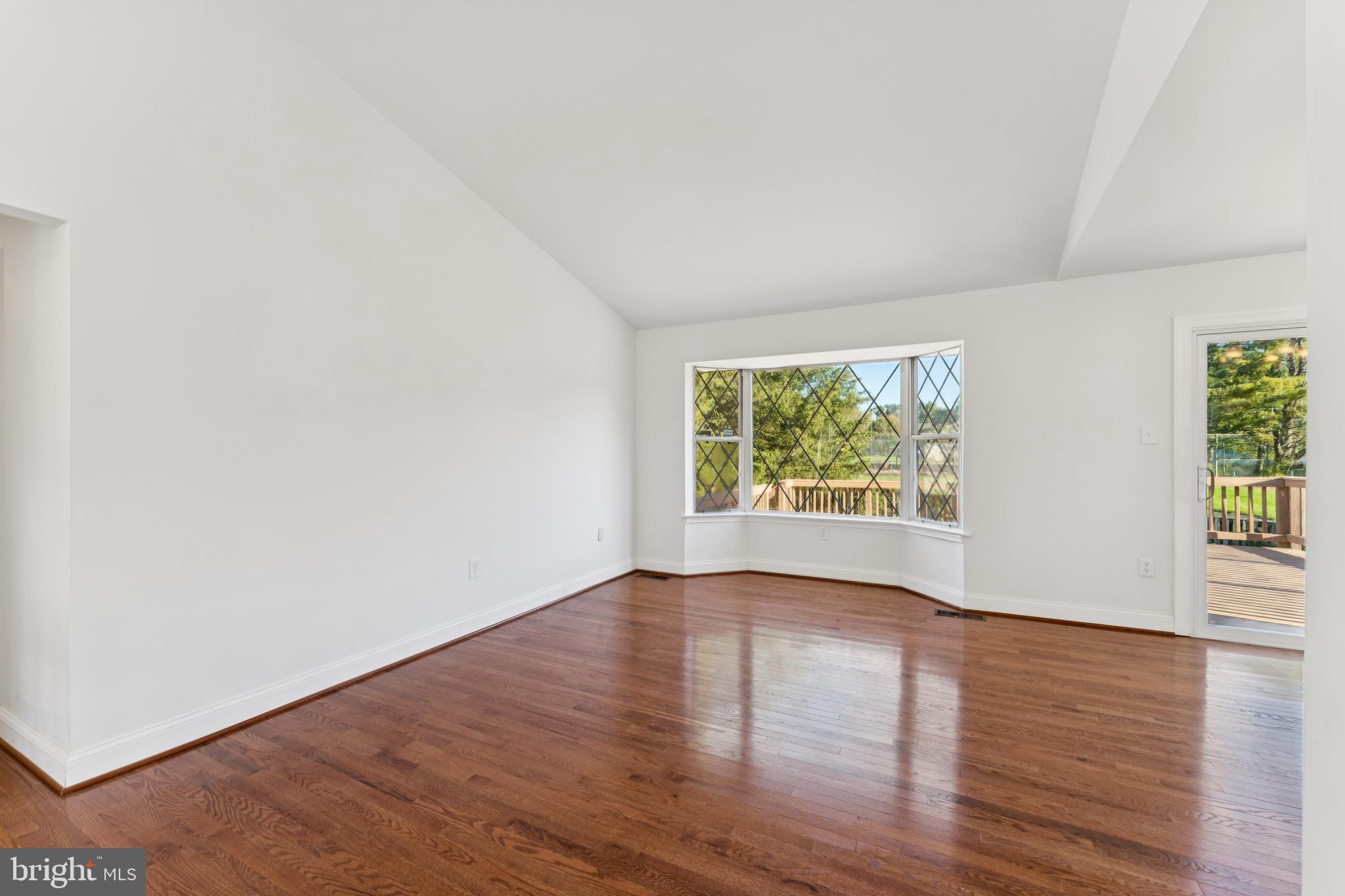 2107 High Timber Road Fort Washington, MD 20744 - Photo 8 of 30 an empty room with wooden floor and windows