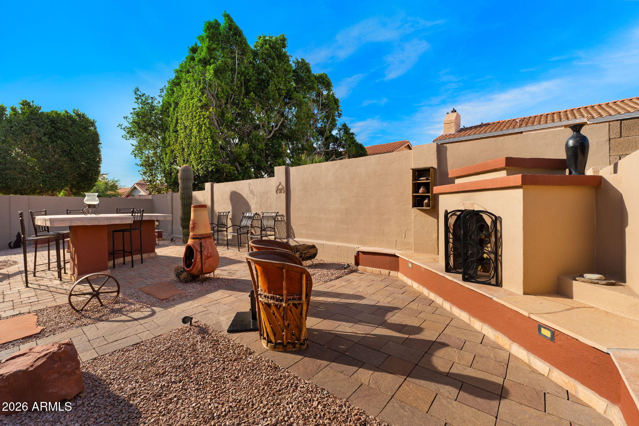 6526 East Raftriver Street Mesa, AZ 85215 - Photo 14 of 17 a view of a patio with table and chairs and a barbeque