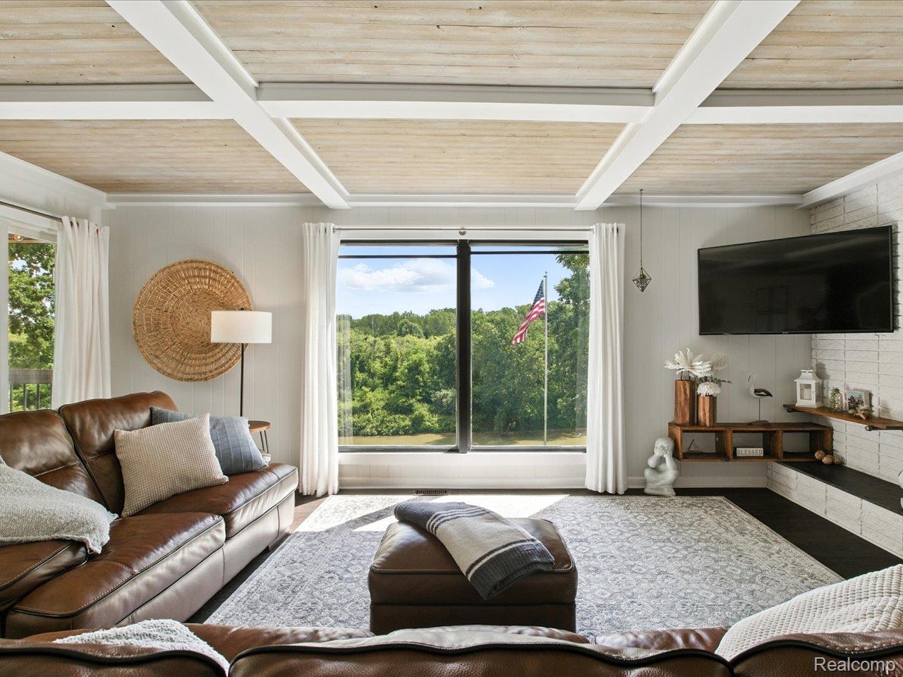 4405 North River Road Fort Gratiot, MI 48059 - Photo 20 of 52 Coffered ceilings in spacious yet intimate family room with fireplace and views of the great outdoors.