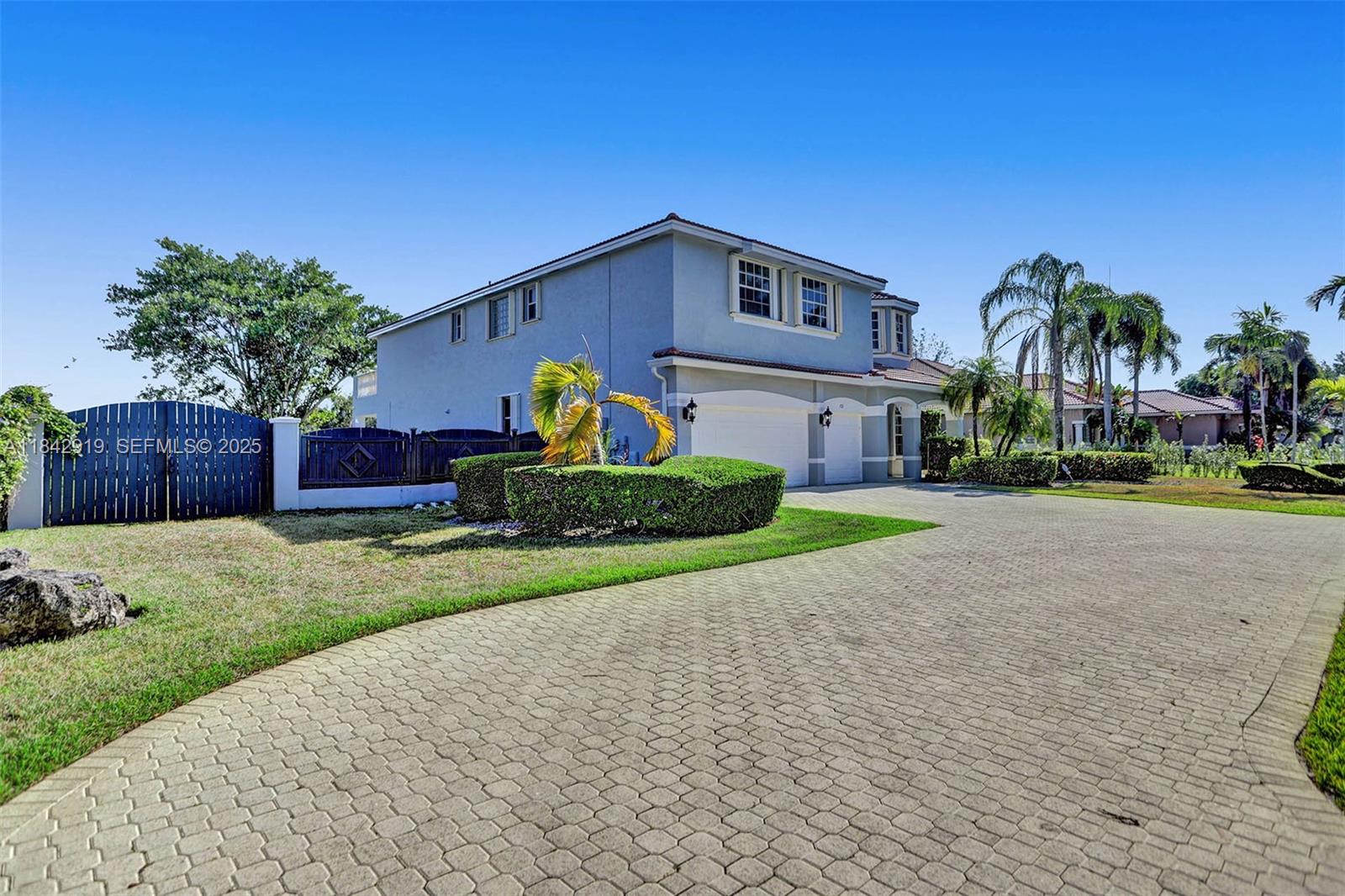 721 Ranch Road Weston, FL 33326 - Photo 14 of 38 a house view with a garden space