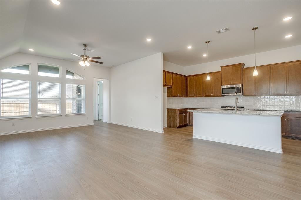 909 Schuberts Road Justin, TX 76247 - Photo 12 of 34 a view of an empty room with a kitchen and a window