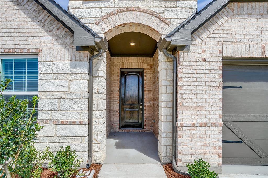 909 Schuberts Road Justin, TX 76247 - Photo 2 of 34 a front view of a house with a garden