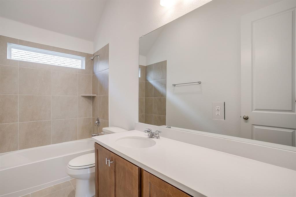 909 Schuberts Road Justin, TX 76247 - Photo 25 of 34 a bathroom with a sink a toilet and shower