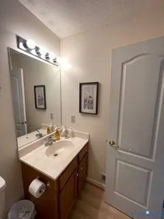 a bathroom with a sink toilet and mirror