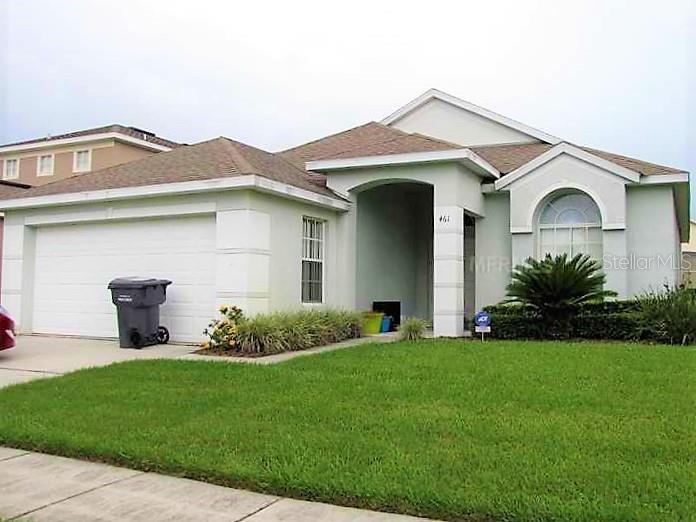 461 Lockbreeze Drive Davenport, FL 33897 - Photo 1 of 1 a front view of a house with a garden
