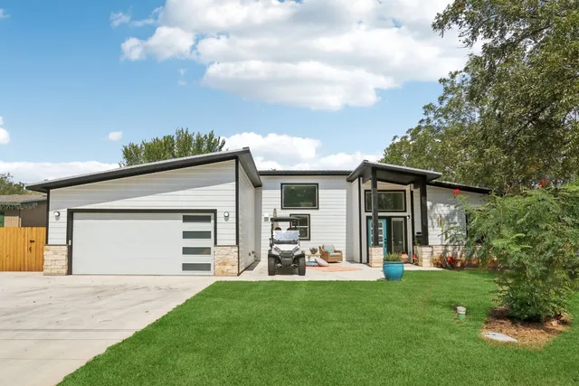 a front view of a house with a garden and yard