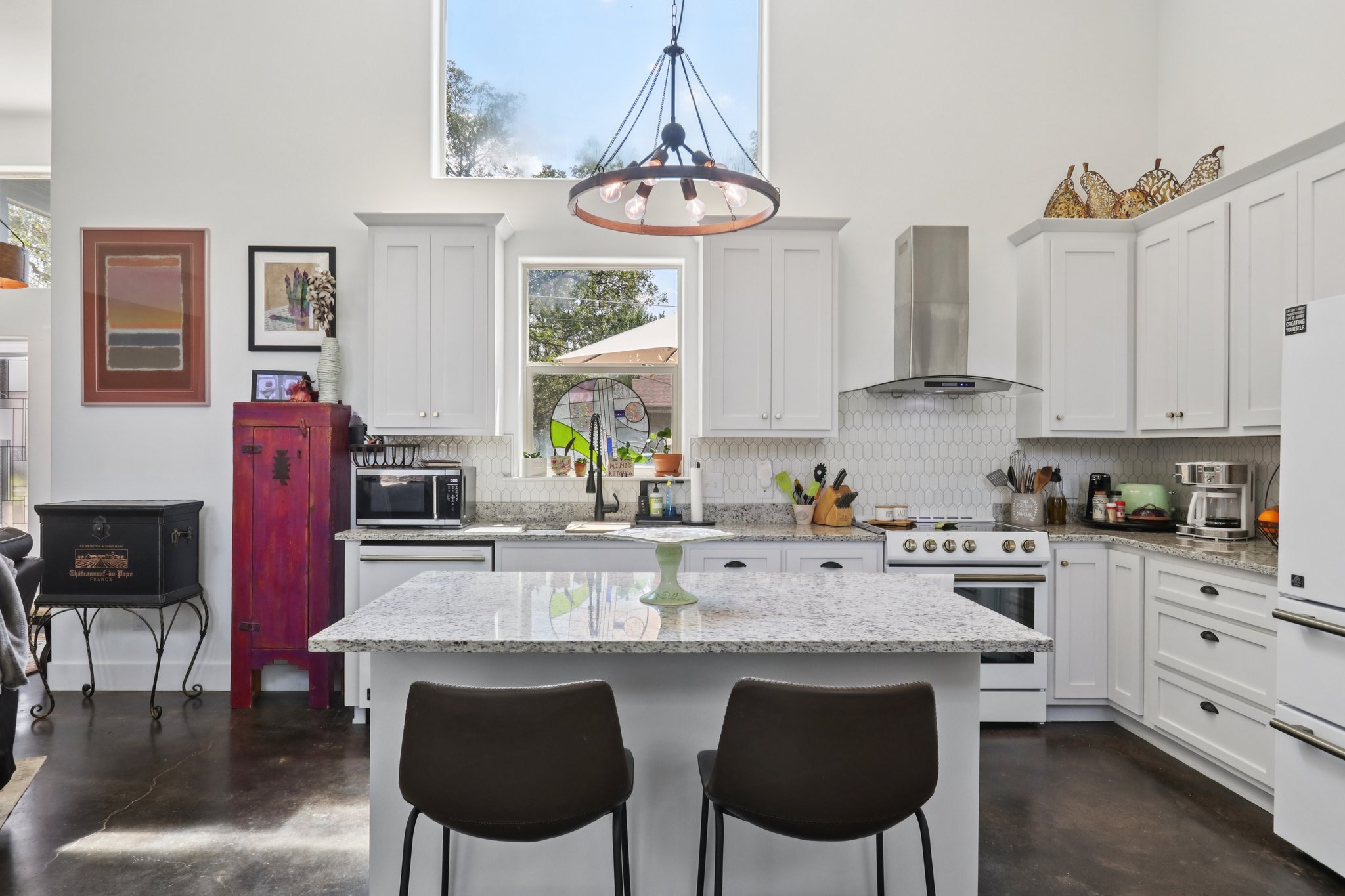 604 Wilhelm Street Bastrop, TX 78602 - Photo 15 of 39 a kitchen with stainless steel appliances granite countertop a table chairs stove and cabinets