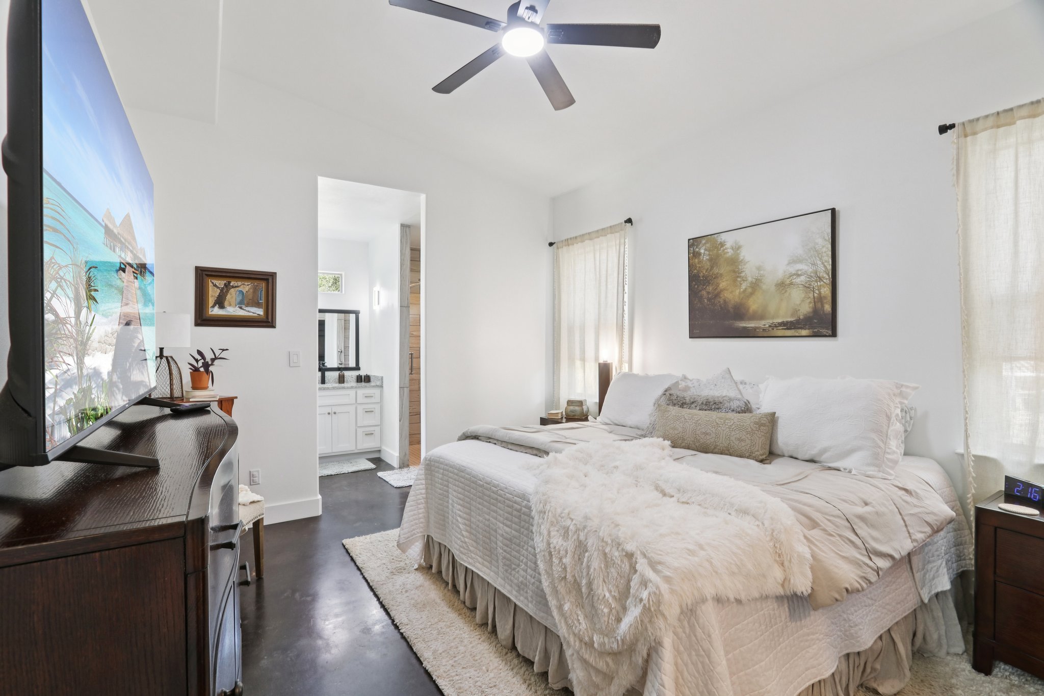 604 Wilhelm Street Bastrop, TX 78602 - Photo 19 of 39 a bedroom with a bed and a chandelier