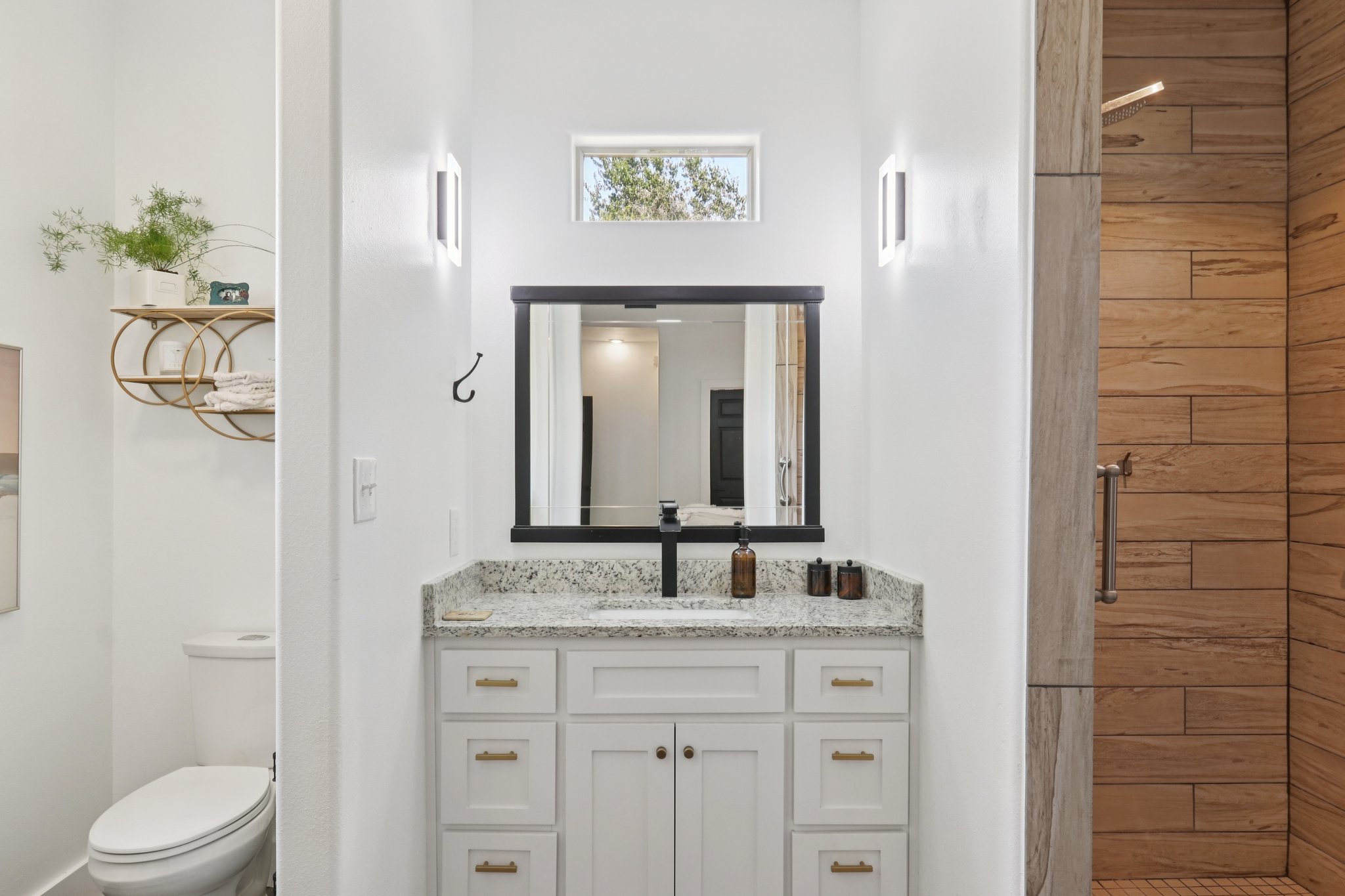 604 Wilhelm Street Bastrop, TX 78602 - Photo 22 of 39 a bathroom with a granite countertop sink toilet a mirror and shower