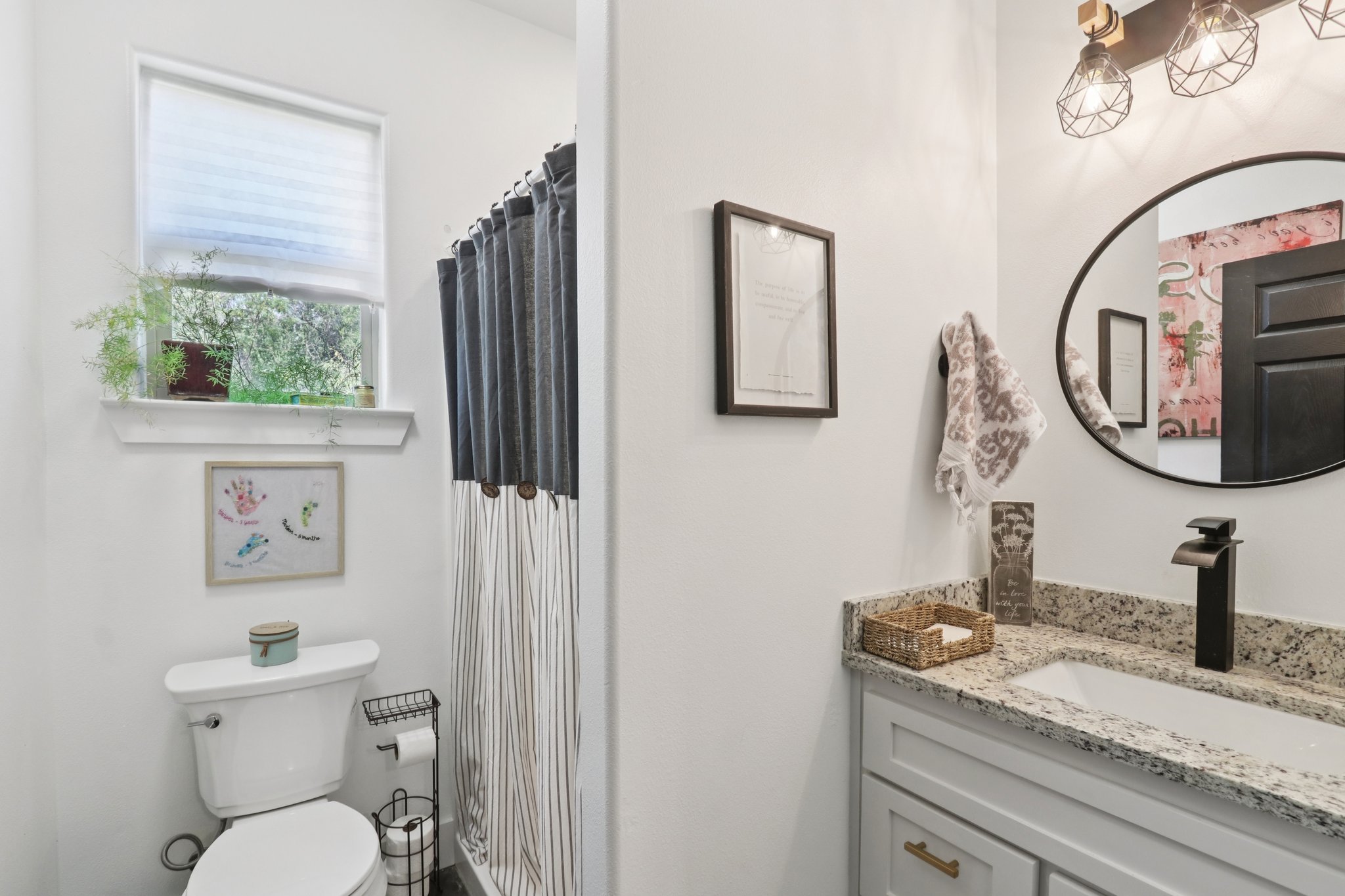 604 Wilhelm Street Bastrop, TX 78602 - Photo 24 of 39 a bathroom with a toilet a sink and mirror