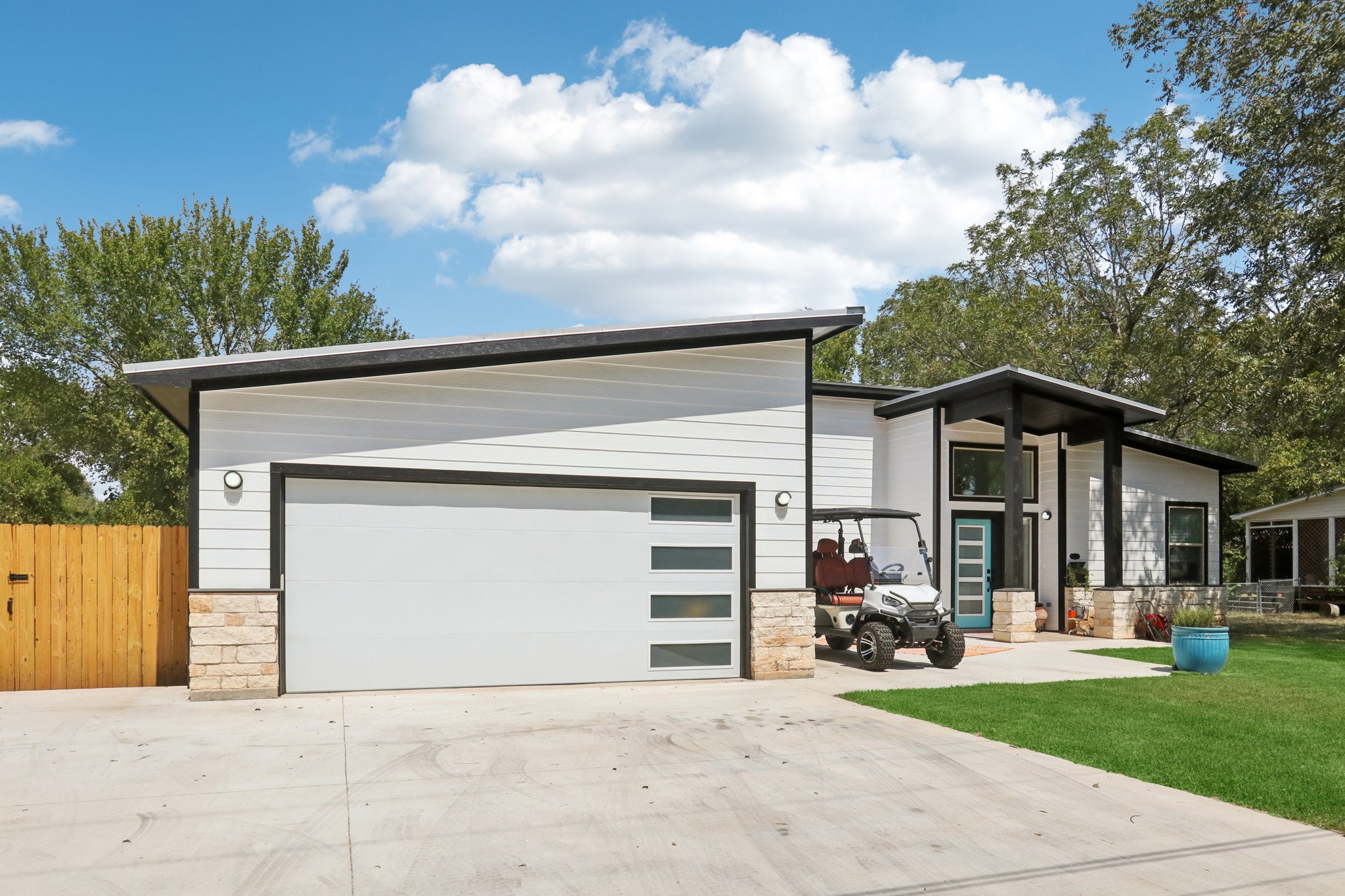 604 Wilhelm Street Bastrop, TX 78602 - Photo 5 of 39 View of front of property with stone siding and driveway