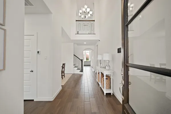 a view of a hallway with wooden floor and staircase
