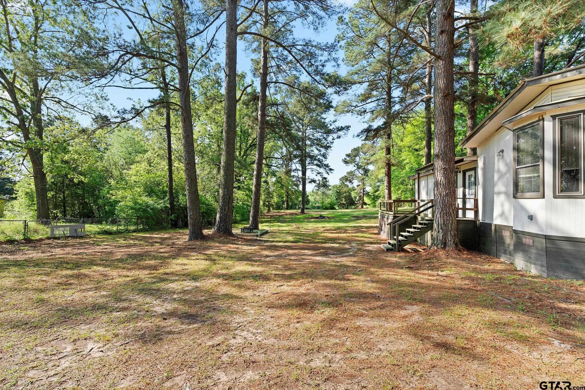 4550 Crabapple Road Gilmer, TX 75645 - Photo 29 of 33 a view of a house with a yard