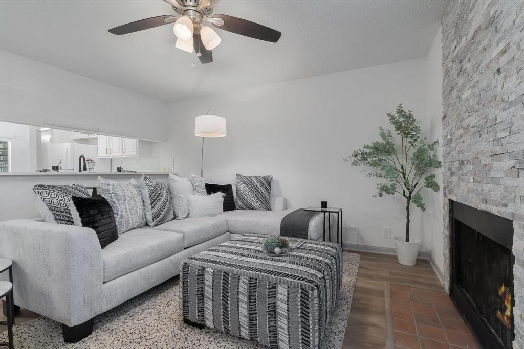 5981 Arapaho Road, Unit 305 Dallas, TX 75248 - Photo 15 of 38 a bedroom with a large bed and a fireplace