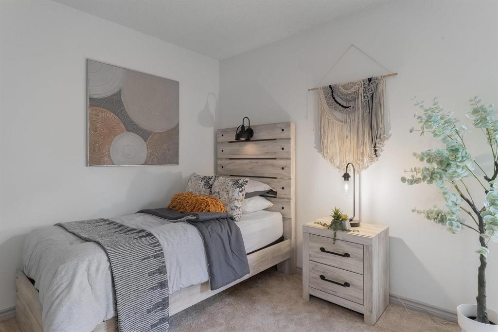 5981 Arapaho Road, Unit 305 Dallas, TX 75248 - Photo 16 of 38 a bedroom with a bed and a potted plant
