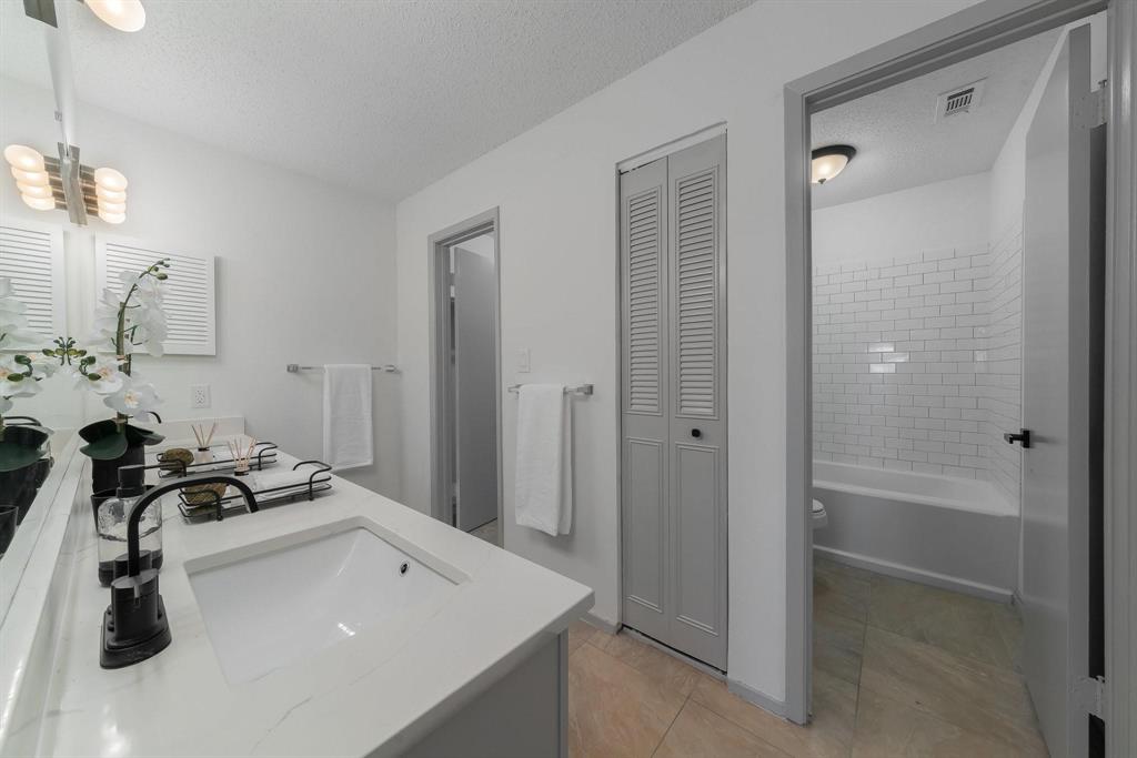 5981 Arapaho Road, Unit 305 Dallas, TX 75248 - Photo 17 of 38 a room with a sink and a mirror