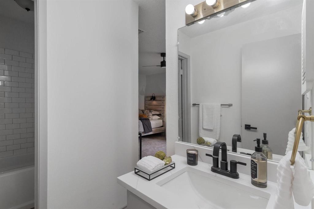 5981 Arapaho Road, Unit 305 Dallas, TX 75248 - Photo 20 of 38 a bathroom with a sink and a mirror