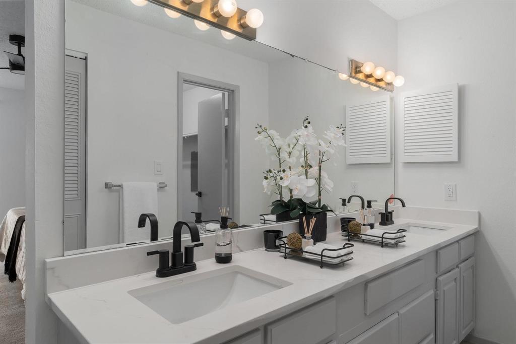 5981 Arapaho Road, Unit 305 Dallas, TX 75248 - Photo 21 of 38 a bathroom with double sink and a mirror