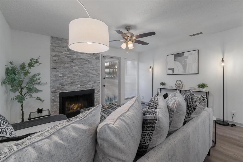 5981 Arapaho Road, Unit 305 Dallas, TX 75248 - Photo 26 of 38 a bedroom with bed and a fireplace