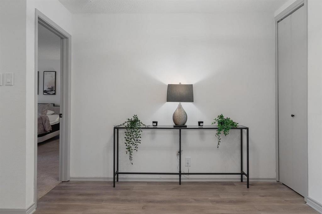 5981 Arapaho Road, Unit 305 Dallas, TX 75248 - Photo 3 of 38 a living room with furniture and a wooden floor