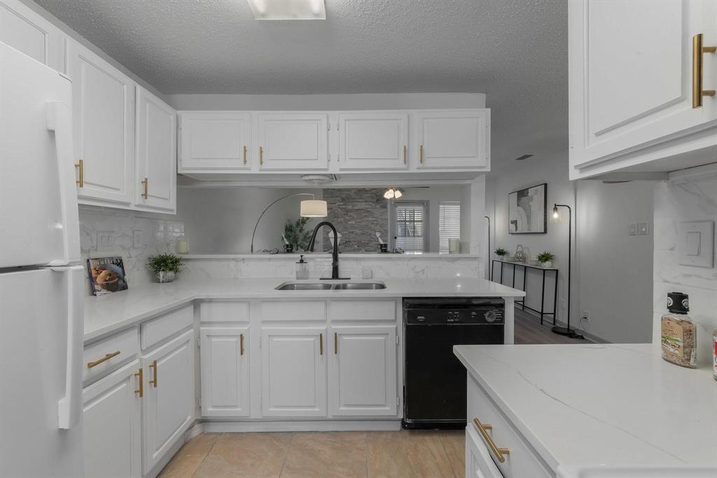 5981 Arapaho Road, Unit 305 Dallas, TX 75248 - Photo 33 of 38 a kitchen with white cabinets and refrigerator