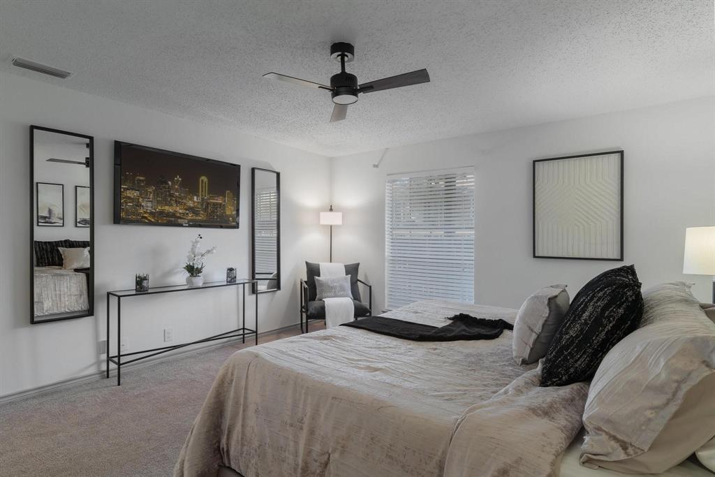 5981 Arapaho Road, Unit 305 Dallas, TX 75248 - Photo 35 of 38 a bedroom with a bed and a flat tv screen on the dresser