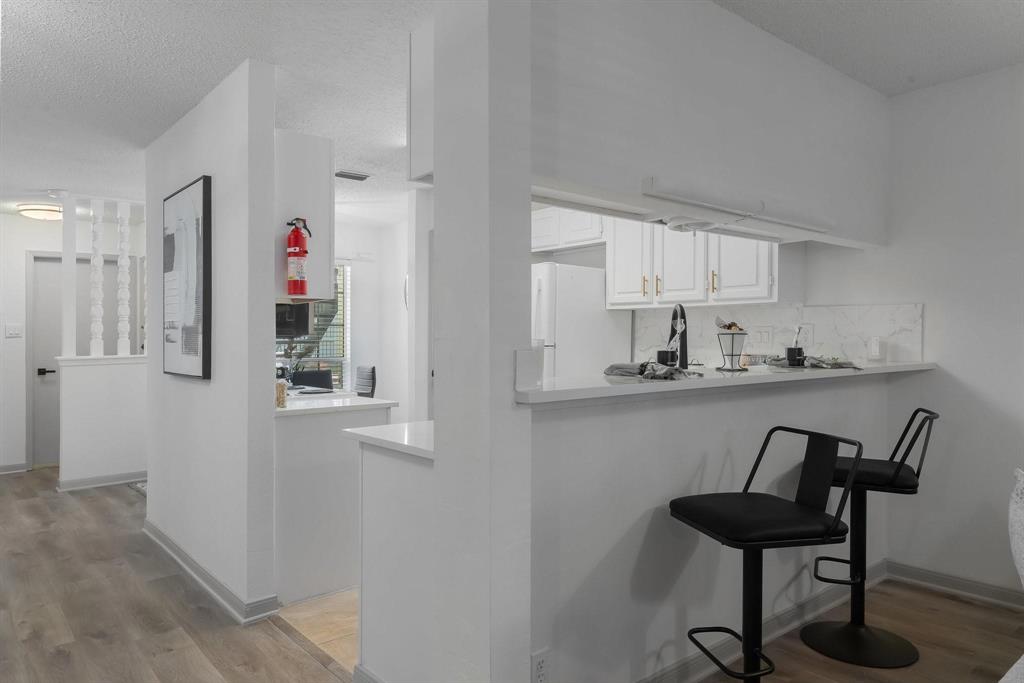 5981 Arapaho Road, Unit 305 Dallas, TX 75248 - Photo 36 of 38 a kitchen with stainless steel appliances granite countertop a refrigerator and a stove top oven