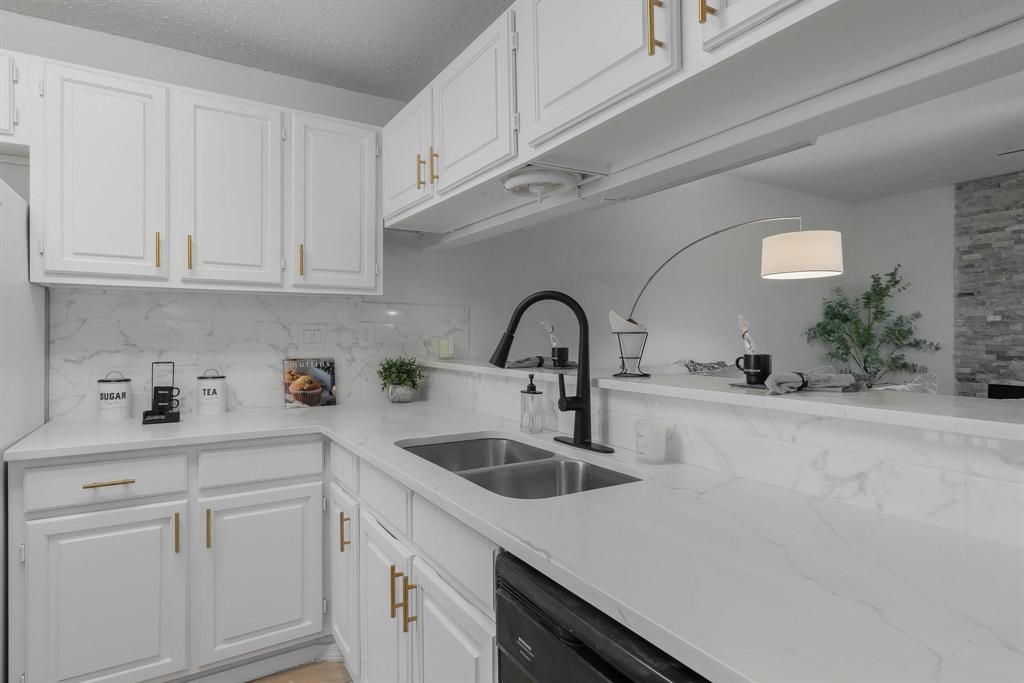 5981 Arapaho Road, Unit 305 Dallas, TX 75248 - Photo 38 of 38 a kitchen with white cabinets a sink and dishwasher