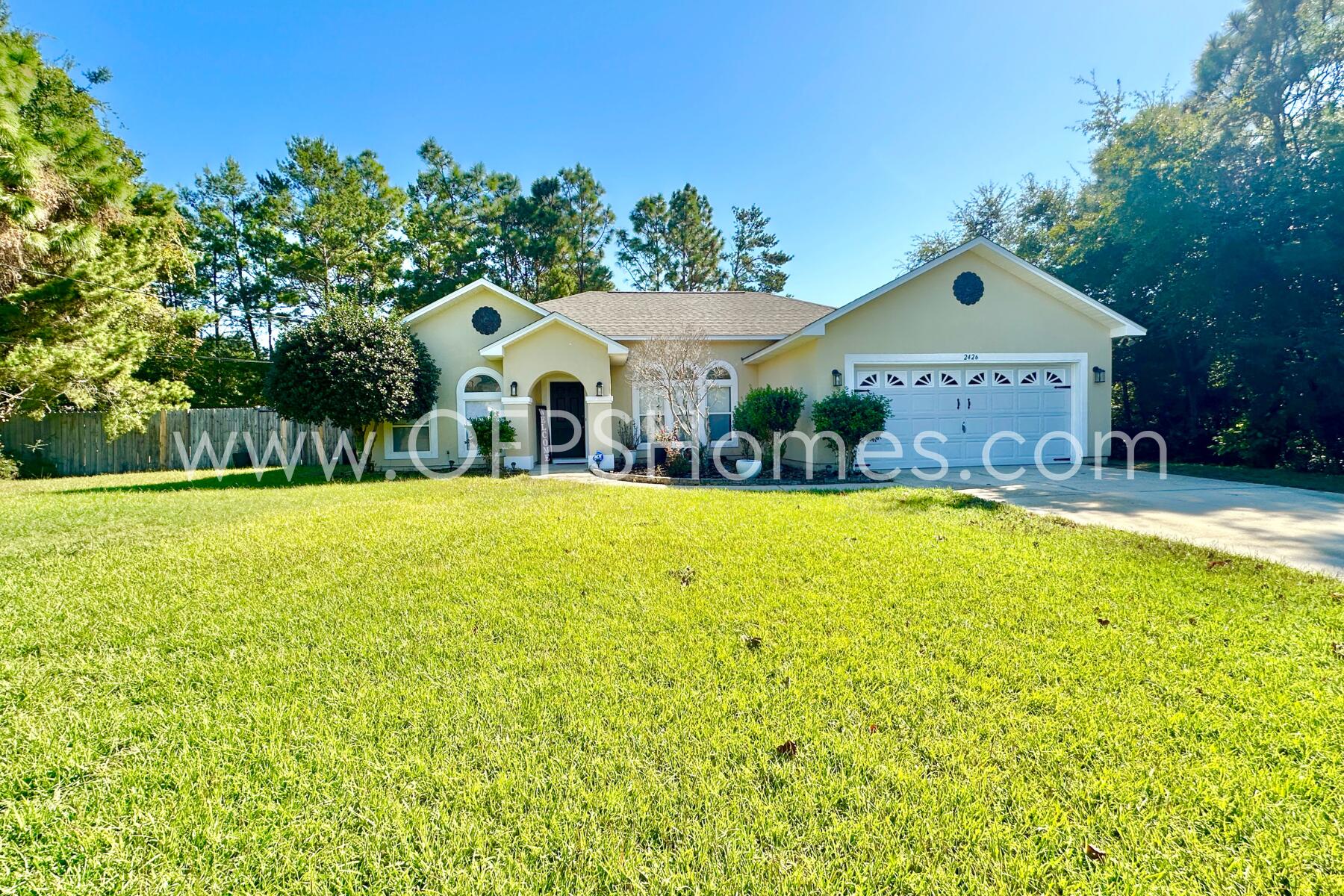 2426 Houston Circle Gulf Breeze, FL 32563 - Photo 1 of 25 a front view of house with yard and green space