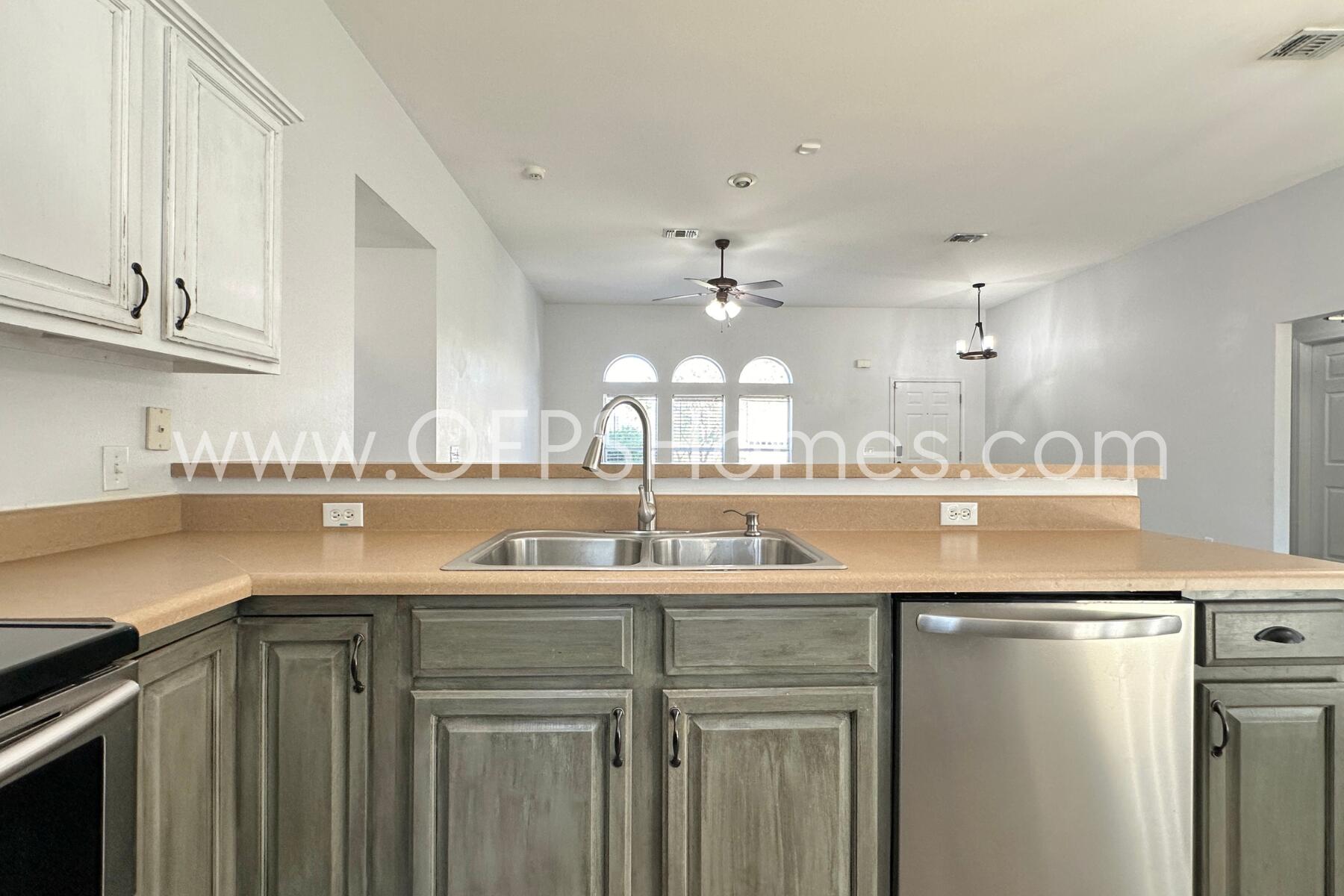 2426 Houston Circle Gulf Breeze, FL 32563 - Photo 11 of 25 a kitchen with kitchen island granite countertop a sink and cabinets