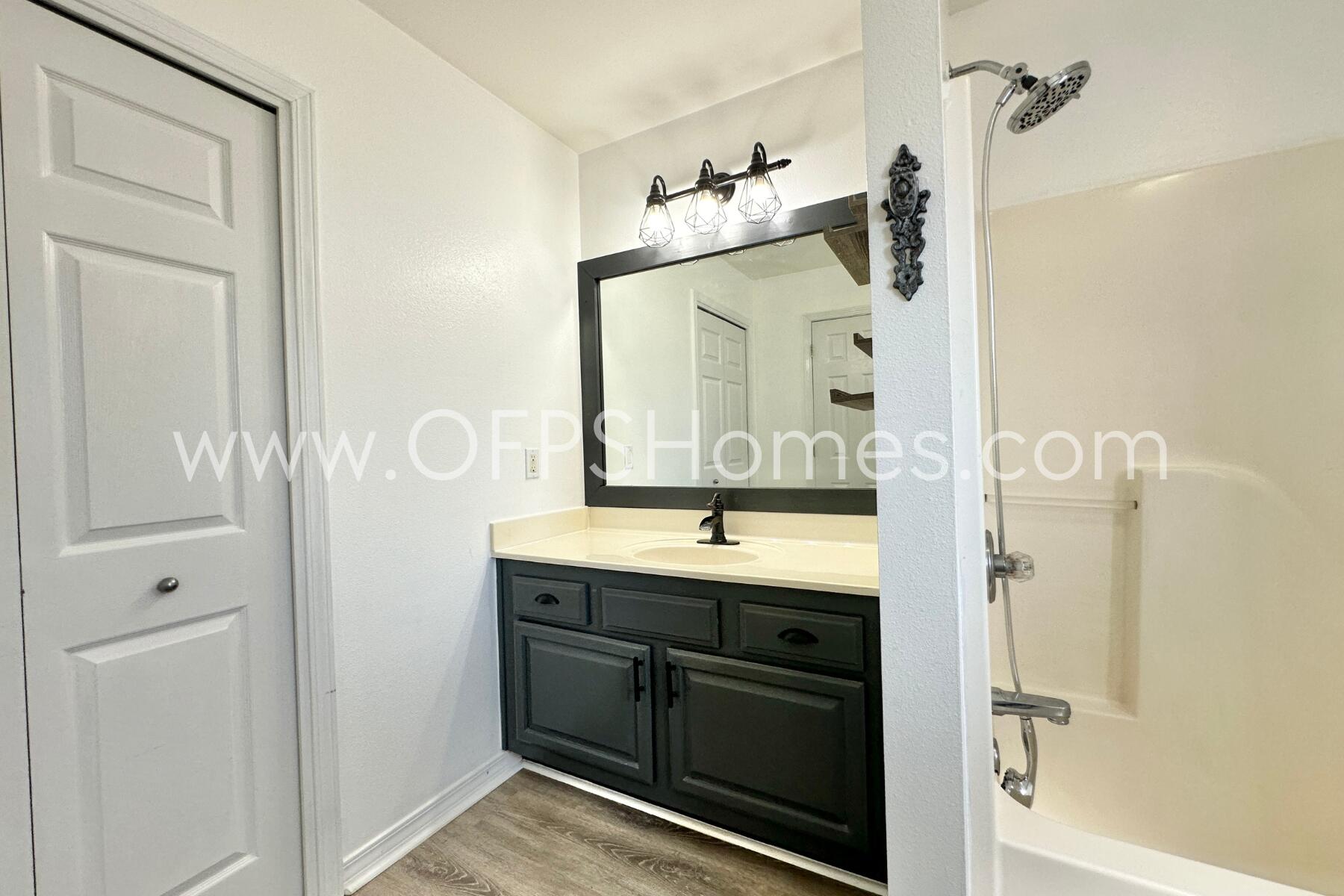 2426 Houston Circle Gulf Breeze, FL 32563 - Photo 17 of 25 a bathroom with a granite countertop shower sink vanity and mirror