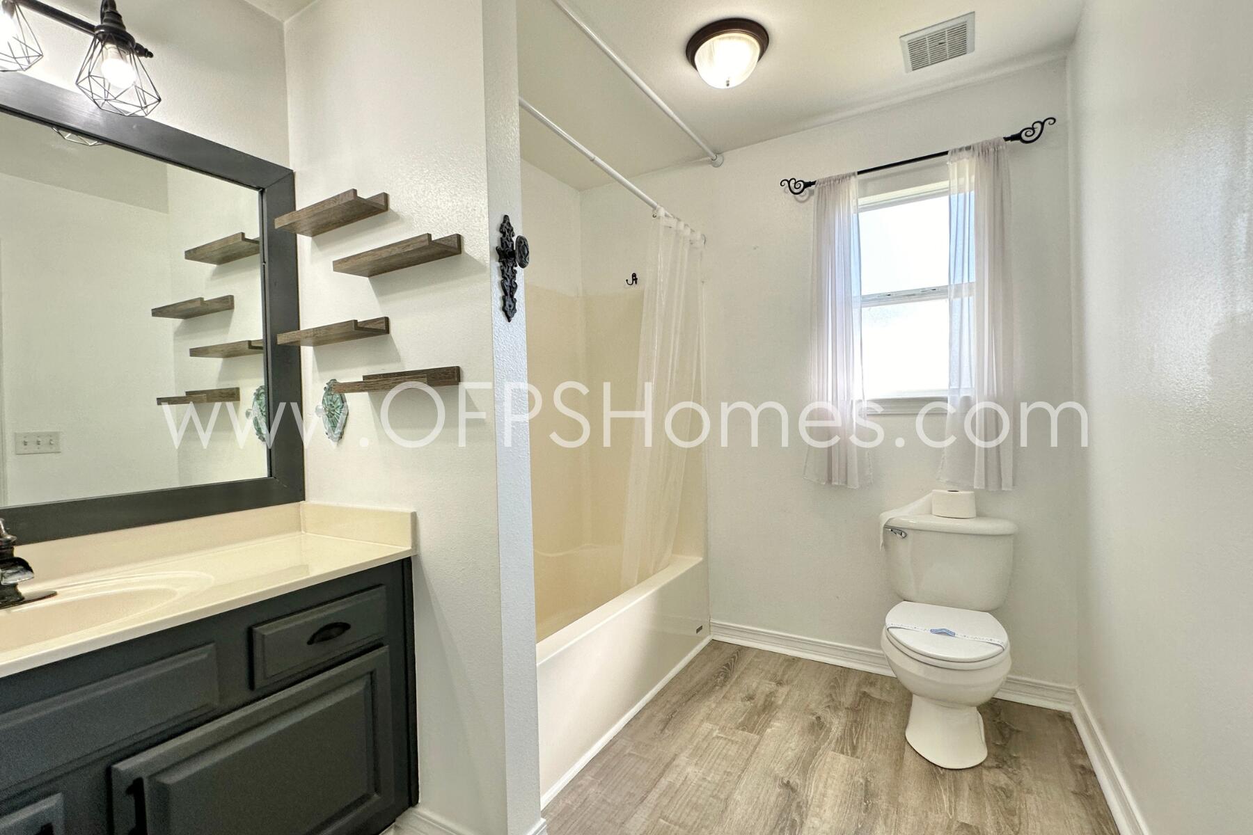 2426 Houston Circle Gulf Breeze, FL 32563 - Photo 18 of 25 a bathroom with a granite countertop toilet a sink and a shower