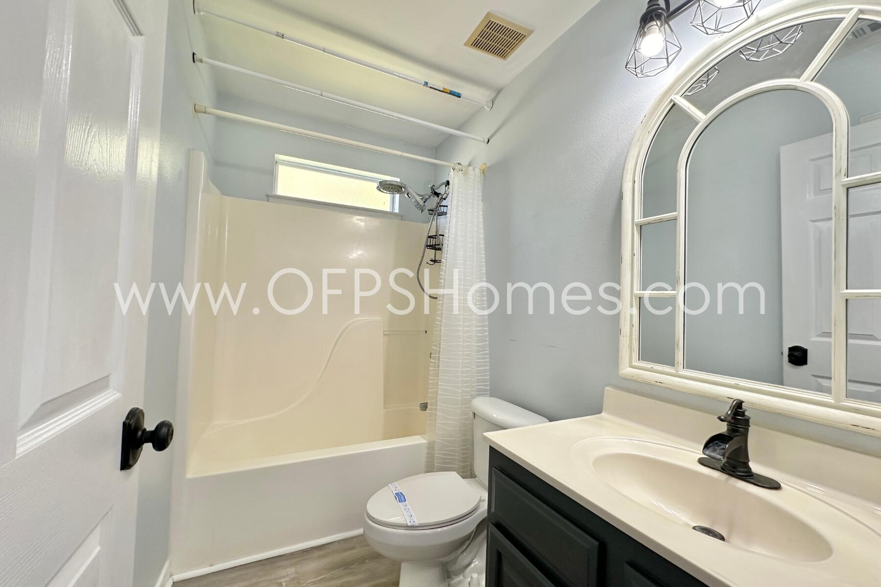 2426 Houston Circle Gulf Breeze, FL 32563 - Photo 21 of 25 a bathroom with a sink a toilet a mirror and shower