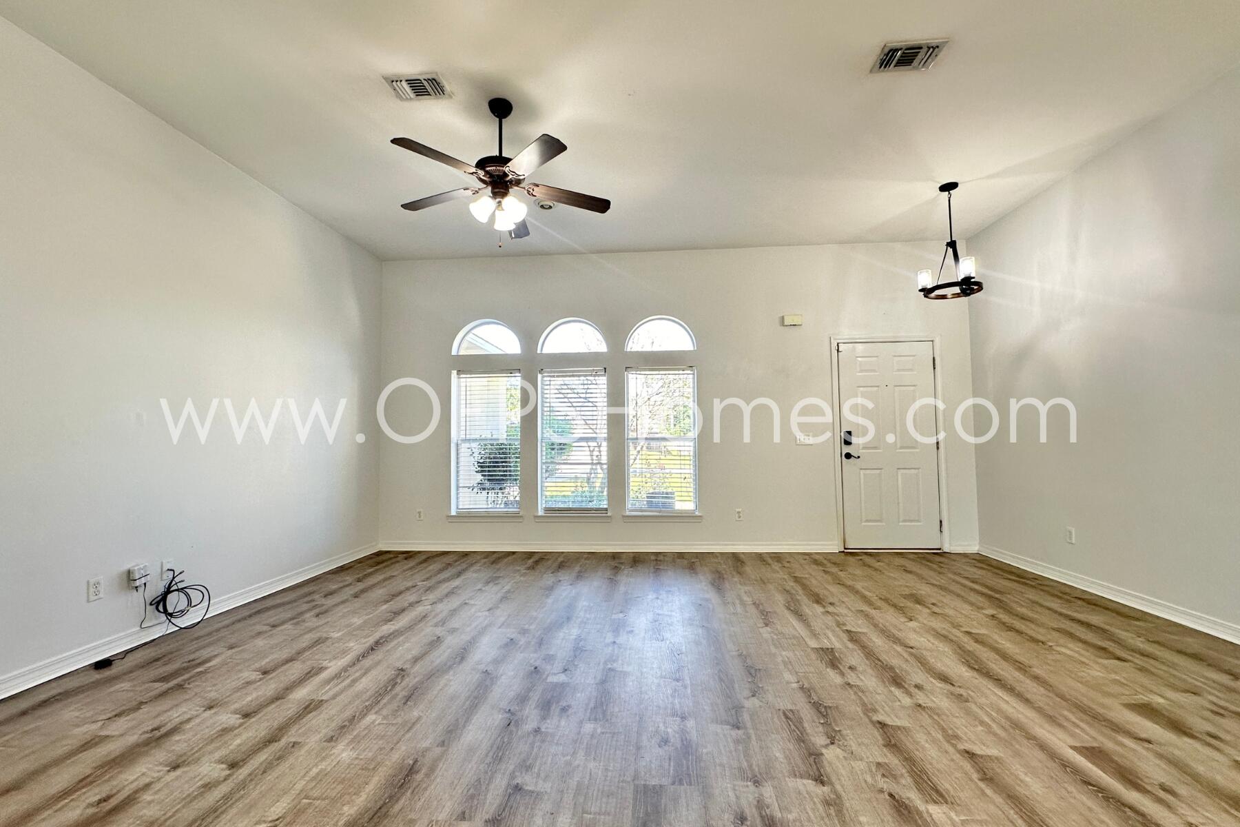 2426 Houston Circle Gulf Breeze, FL 32563 - Photo 6 of 25 a view of an empty room with a window and wooden floor