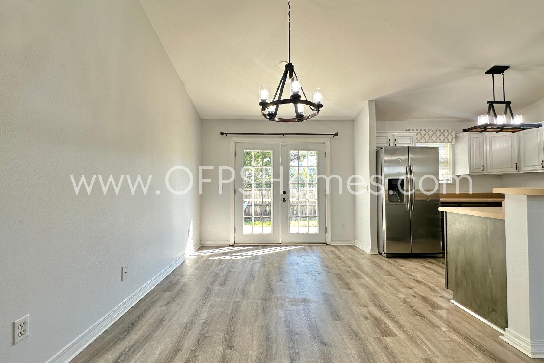 2426 Houston Circle Gulf Breeze, FL 32563 - Photo 8 of 25 a view of a kitchen with refrigerator and wooden floor