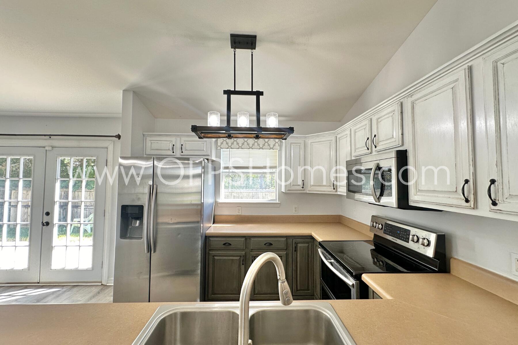 2426 Houston Circle Gulf Breeze, FL 32563 - Photo 10 of 25 a kitchen with stainless steel appliances granite countertop a refrigerator a sink and white cabinets