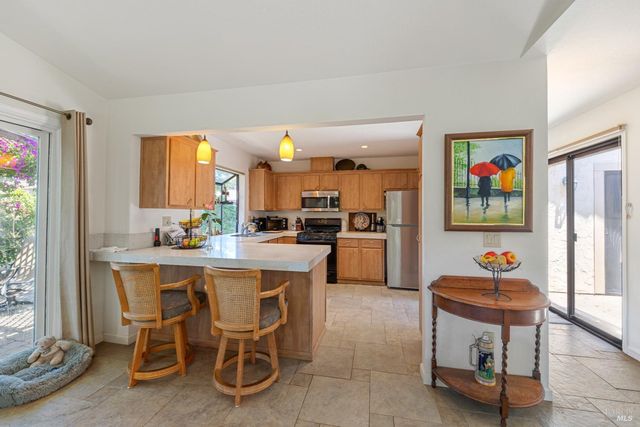 a kitchen with a sink cabinets and window