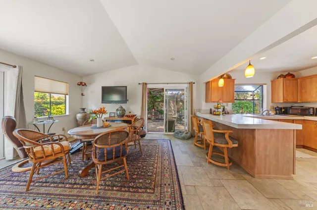 a view of a dining room with furniture window and outside view