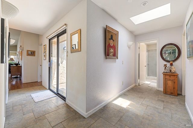 a view of a hallway with entryway door