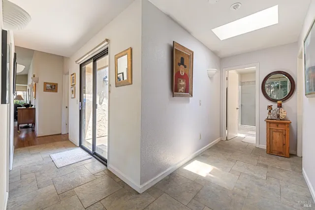 a view of a hallway with entryway door