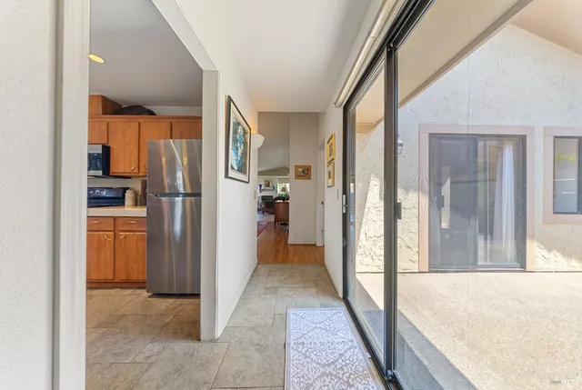 a view of a kitchen with refrigerator and a sink
