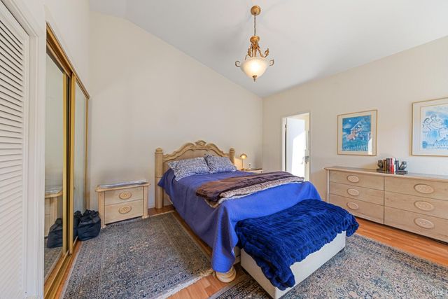 a bedroom with a bed and a mirror