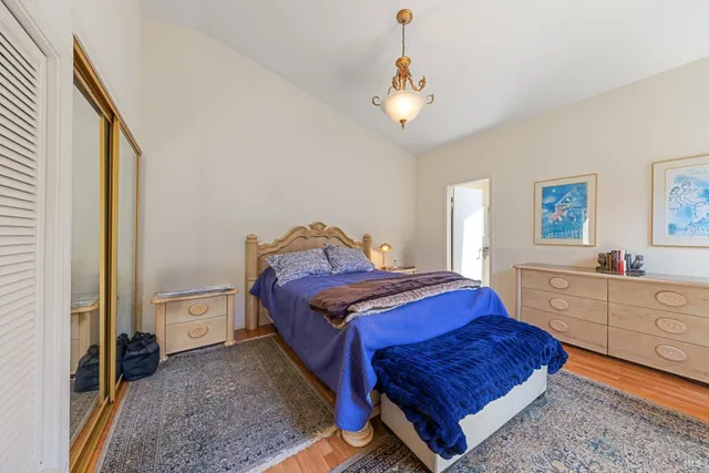 a bedroom with a bed and a mirror